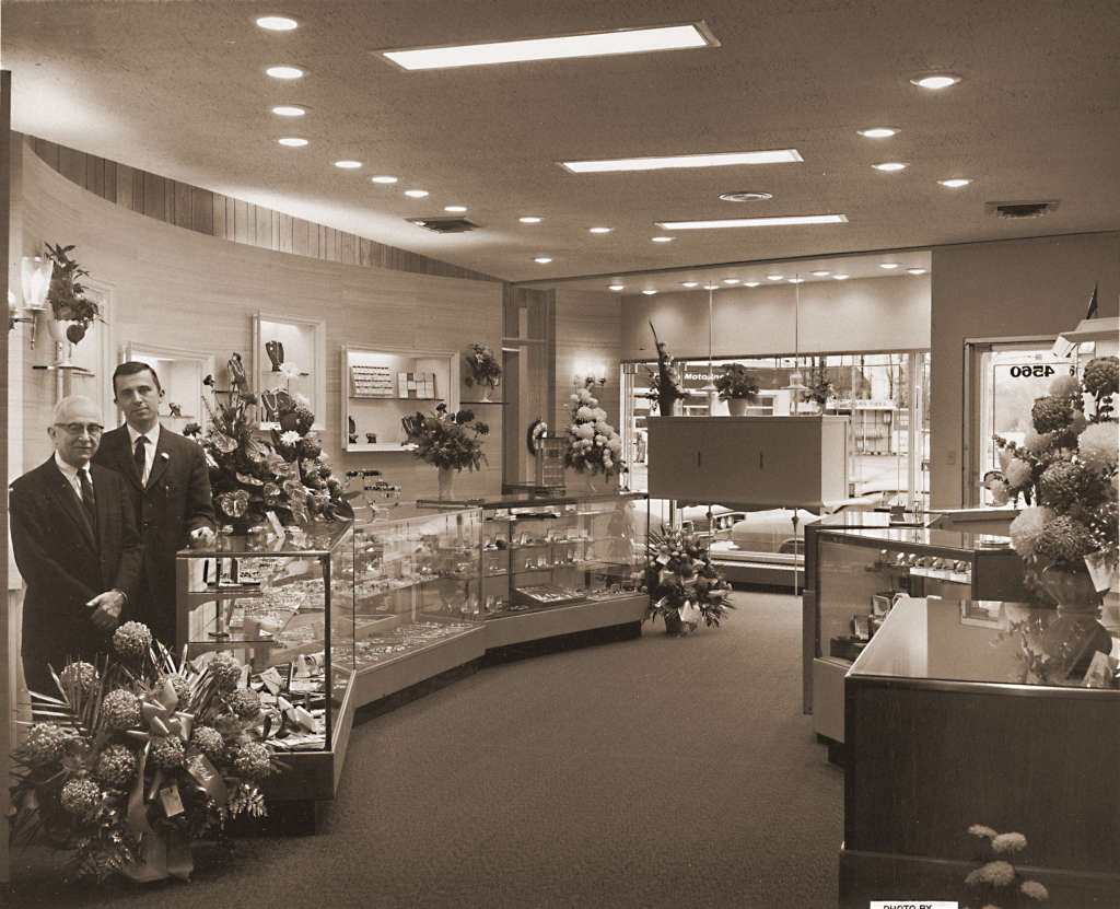 Second and third geneation of Scherers Jewelers stand in new jewelry store in 1967