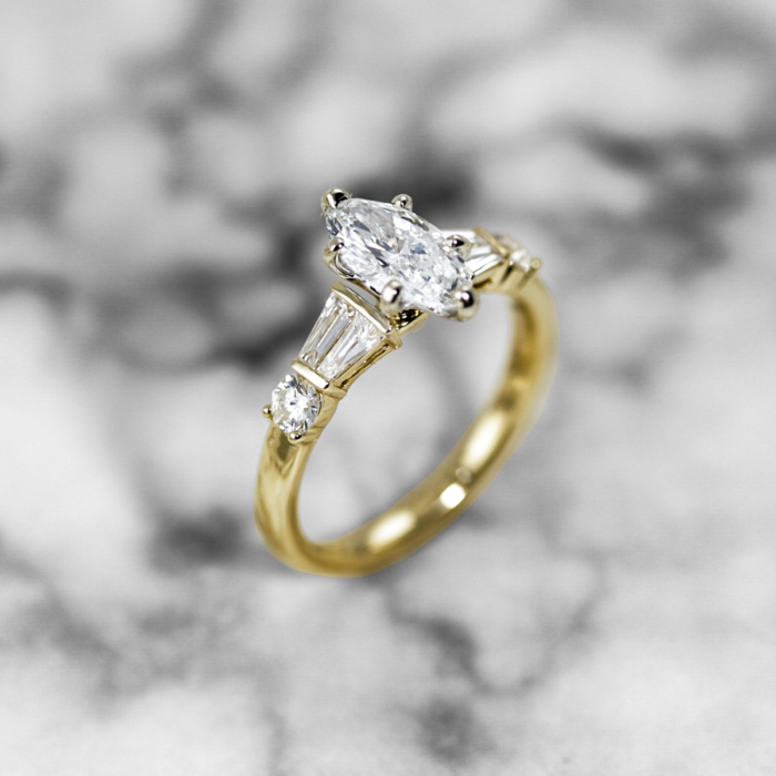 Marquise diamond ring with double taper baguette sides