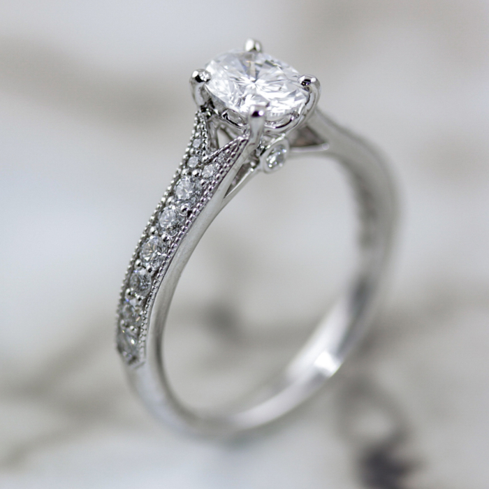 Oval diamond ring with mill-grain