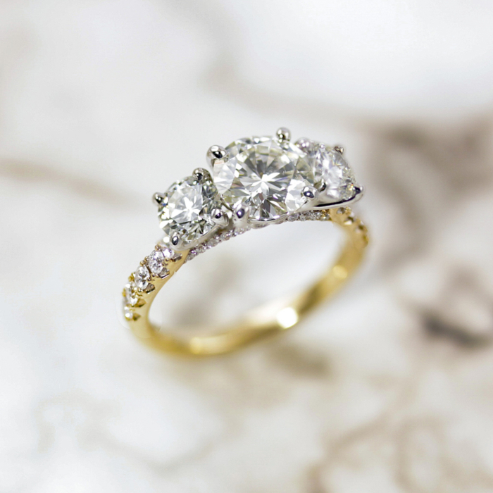 Three stone diamond ring with accent diamonds